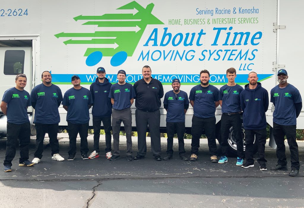 crew(edit) About Time Moving crew and their fearless leader standing in front of a moving truck