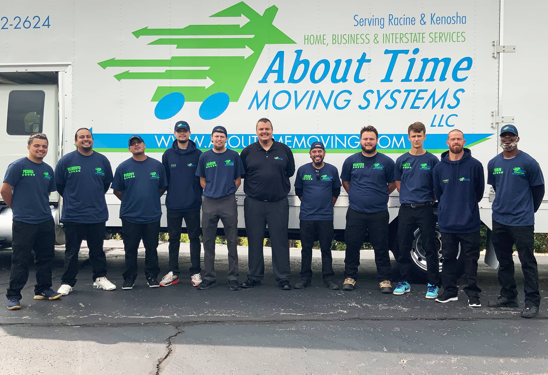 About Time Moving crew and their fearless leader standing in front of a moving truck